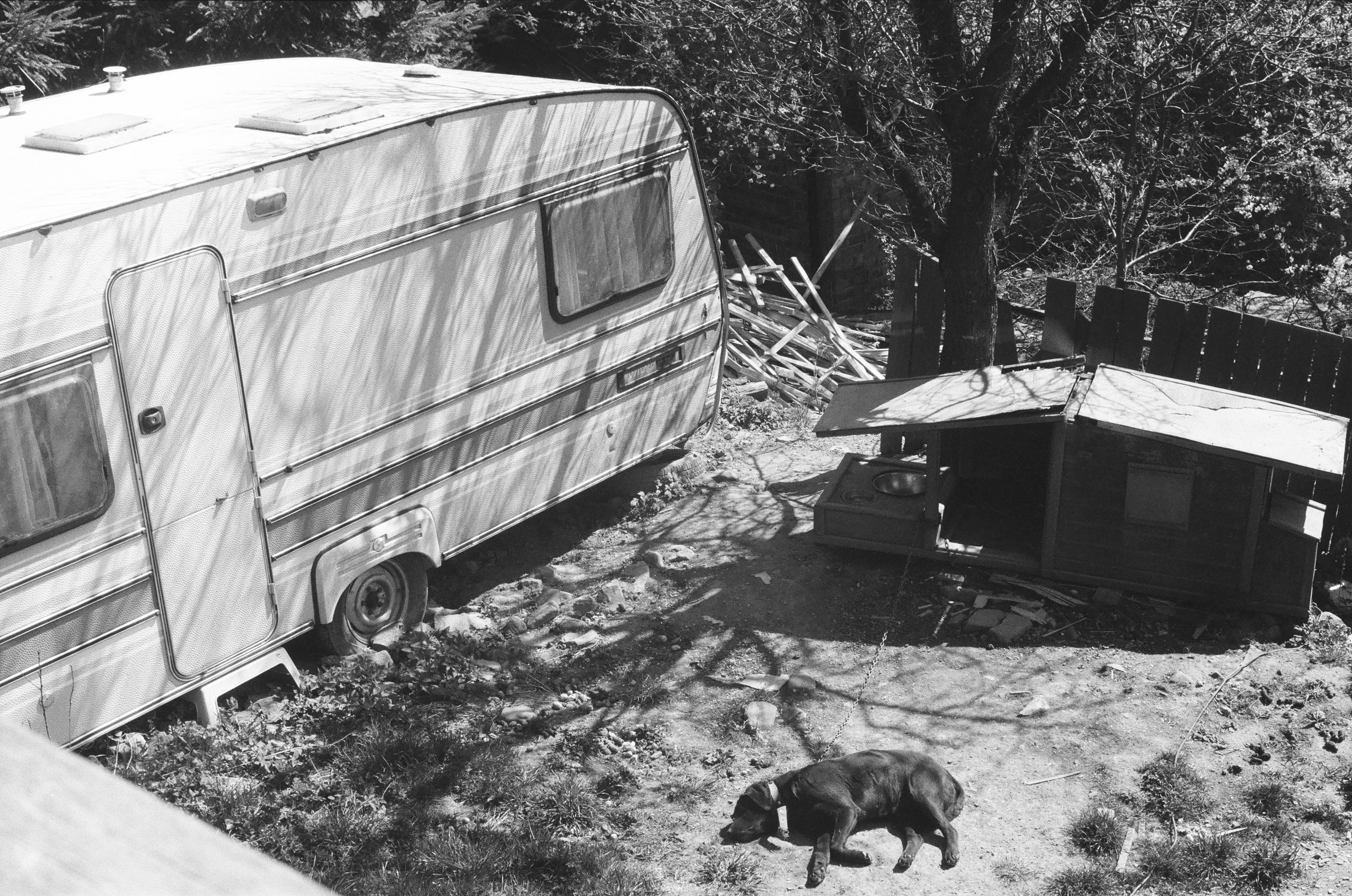 grayscale photo of white and brown camper trailer